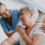 A female caregiver helping an older woman with stroke recovery at home.